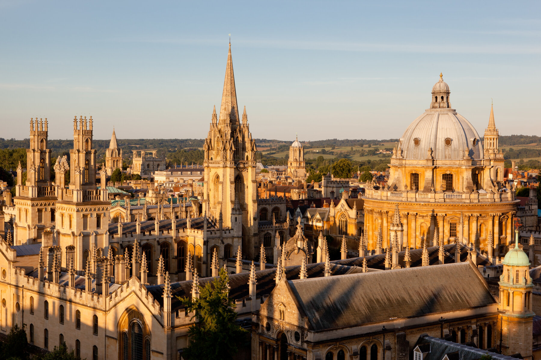Sunlit Oxford skyline with stone towers, spires and a domed building, photographed by James Whitaker